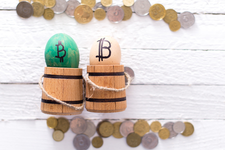 Egg with bitcoin in a wooden small barrel.の写真素材