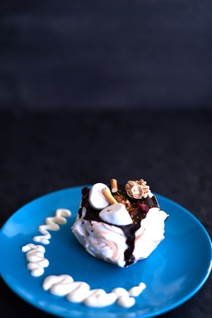 Cake on a blue plate on a black background.の写真素材