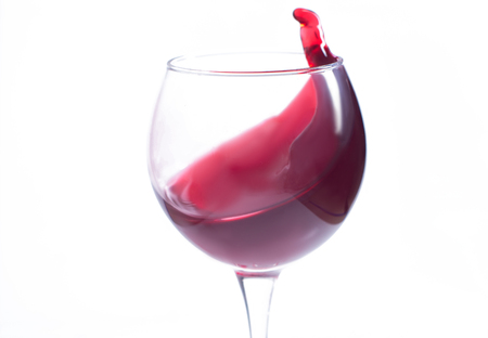 A glass with red wine on a white background. Isolate.の写真素材