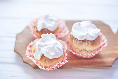 Cupcakes with white cream on a wooden background.の写真素材