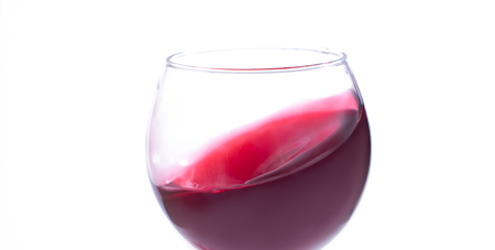 A glass with red wine on a white background. Isolate.の写真素材