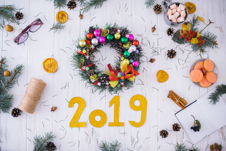 Christmas wreath with New Year's decor on a white wooden background.の写真素材