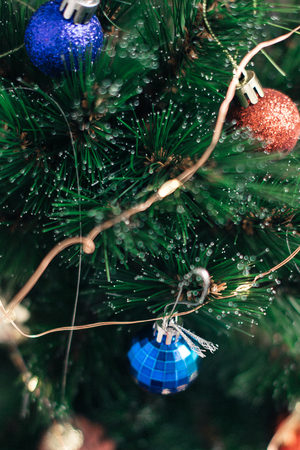 Christmas decorations on the tree with blurred background.の写真素材