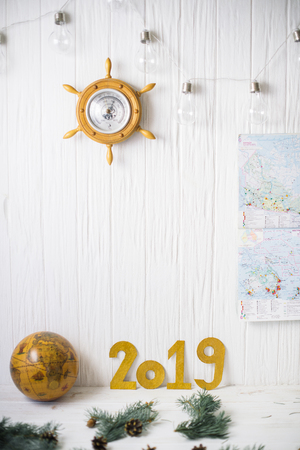 Globe near numbers 2019 on a white wooden background.の写真素材