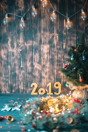 Christmas tree with golden numbers 2019 on a wooden background.の写真素材