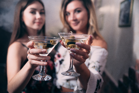 Girls with glasses of white wine in a nightclub.の写真素材
