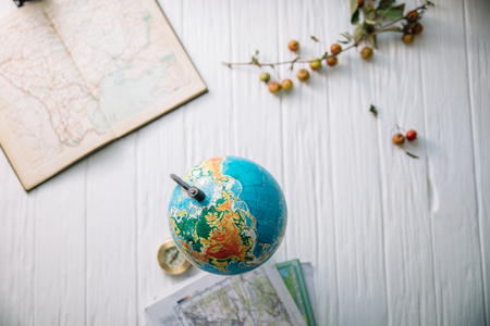 Globe on wooden white boards. Flat lay.の写真素材