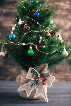 Christmas tree on a wooden blurred background.の写真素材