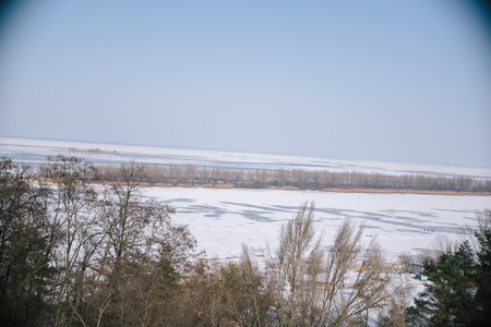 A spring sunny day in a snowy park.の写真素材