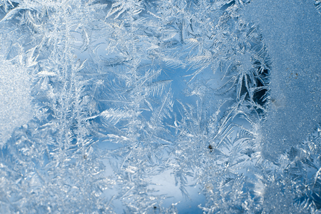 Frosty patterns on the frozen window are macro. Winter background.の写真素材