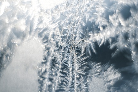 Frosty patterns on the frozen window are macro. Winter background.の写真素材