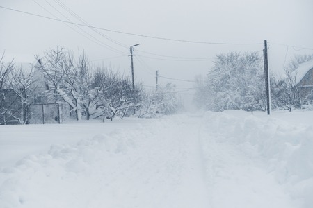 Winter snowfall in the village. Snowy collapse.