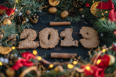 Handmade Christmas wreath on wooden background flat lay