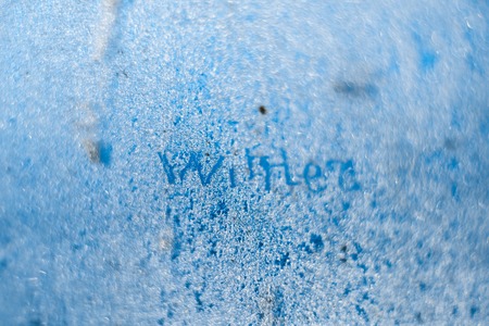 The inscription: winter on a frozen winter window. Background.の写真素材