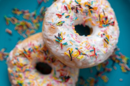 Donuts with scattering on a blue background close-up.の写真素材