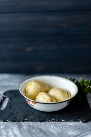 Ready meal - dumplings on a black cement background.の写真素材