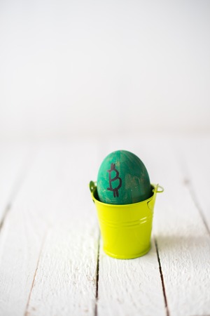 Egg with logo bitcoin in a small bucket.の写真素材