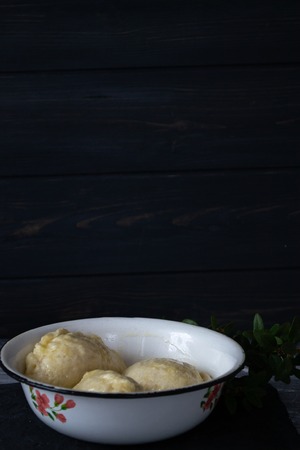 Ready meal - dumplings on a black cement background.の写真素材
