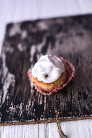 Cupcakes with white cream on a wooden background.の写真素材