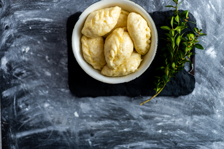 Ready meal - dumplings on a black cement background.の写真素材