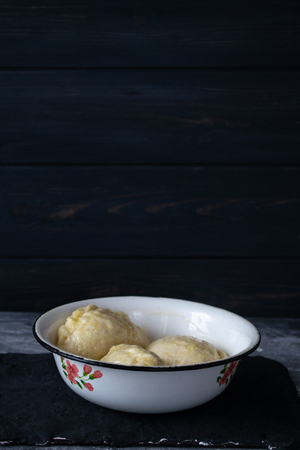 Ready meal - dumplings on a black cement background.の写真素材