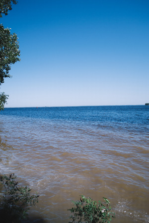 Sunny day on the beach near the river.の写真素材