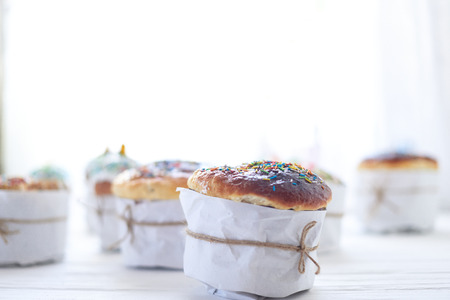 Easter cakes on a white wooden background.の写真素材