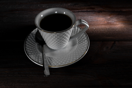 Cup of coffee on a dark wooden background.の写真素材