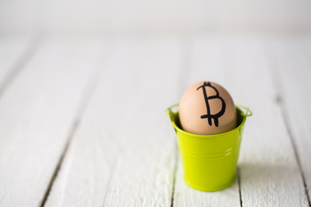 Egg with logo bitcoin in a small bucket.の写真素材