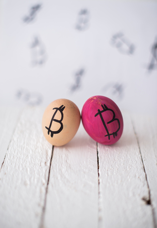 Bitcoin eggs on a wooden blurred background.の写真素材