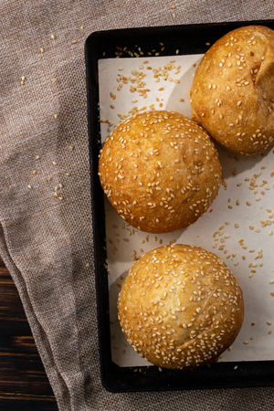 Homemade buns on burlap on wooden background.の写真素材