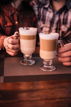The guy and the girl in love in a cafe drink coffee and eat cake.の写真素材