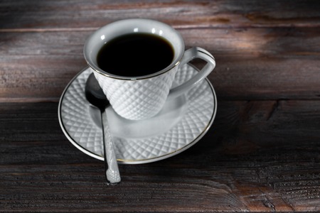 Cup of coffee on a dark wooden background.の写真素材