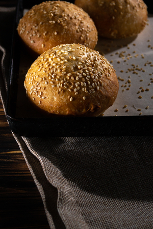 Homemade buns on burlap on wooden background.の写真素材