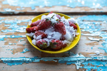 Frozen strawberries on a wooden blue background.の写真素材