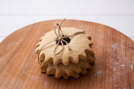 Tied homemade cookies in a stack. With blurred background.の写真素材