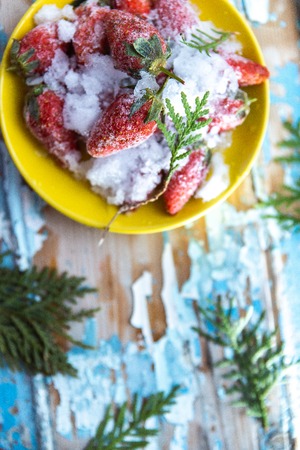 Frozen strawberries on a wooden blue background.の写真素材