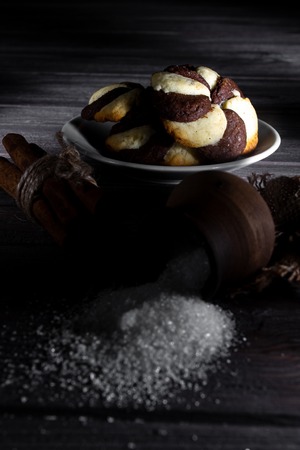 Cookies and barrel small with sugar on a dark wooden background.の写真素材