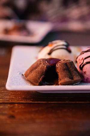 Cupcake in a cafe on a wooden background on a white plate.の写真素材