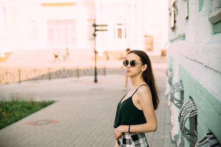 Sexy girl in a T-shirt and short shorts near the building.の写真素材