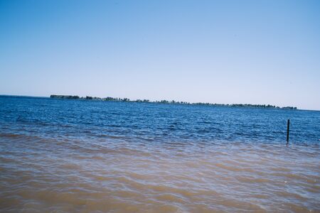 Sunny day on the beach near the river.の写真素材