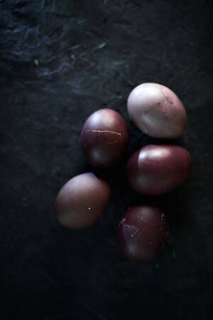 Dark purple eggs on a rough cement background.の写真素材