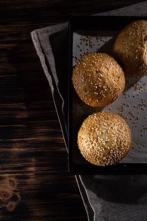 Homemade buns on burlap on wooden background.の写真素材
