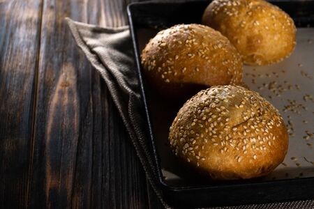 Homemade buns on burlap on wooden background.の写真素材