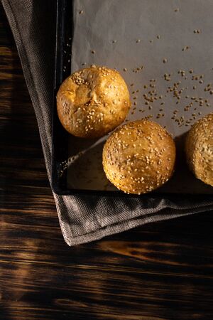 Homemade buns on burlap on wooden background.の写真素材