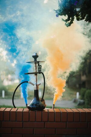Hookah outdoors on a background of colored smoke.の写真素材