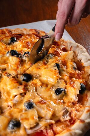 Pizza on a wooden dark background in a bar.の写真素材