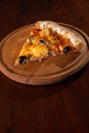 Pizza on a wooden dark background in a bar.の写真素材