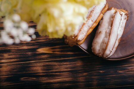 Choux cake on a wooden background with tulips.