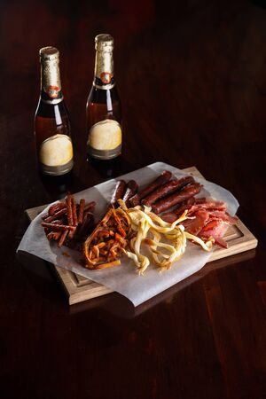 sausage snacks on a wooden background for beer.の写真素材